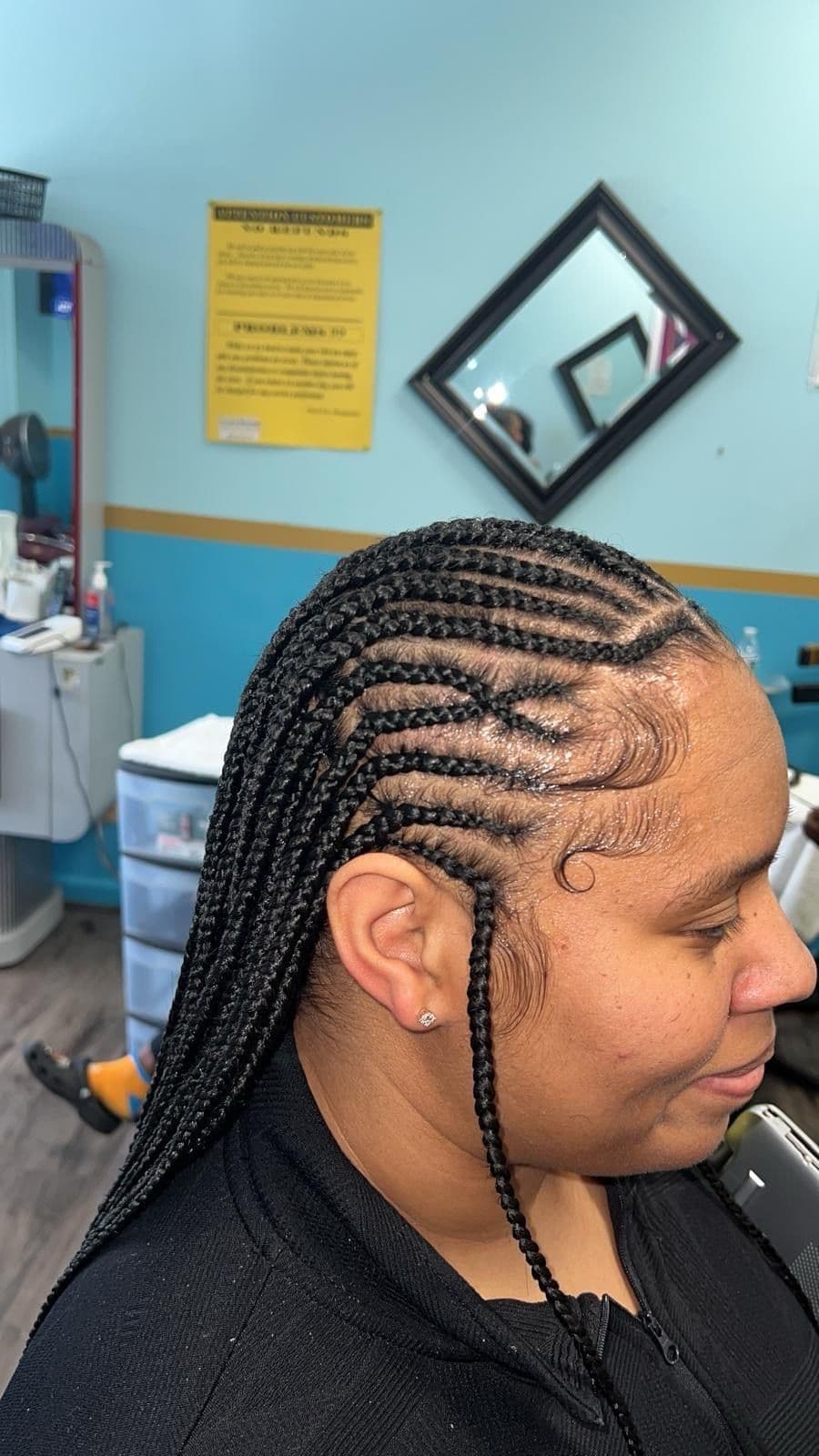 Curved Parts cornrows at the top with knotless braids at the back